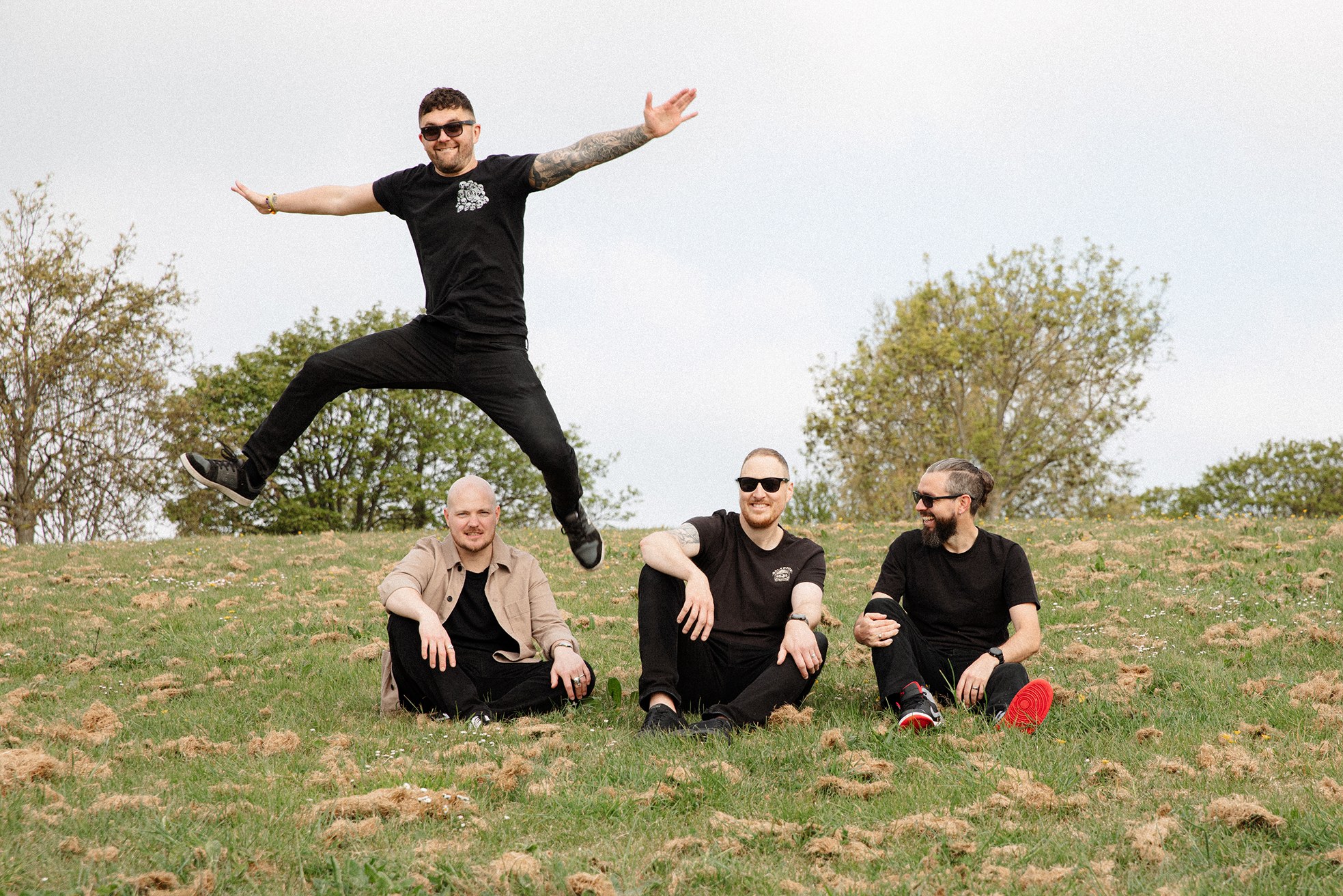 A band member leaping in a field